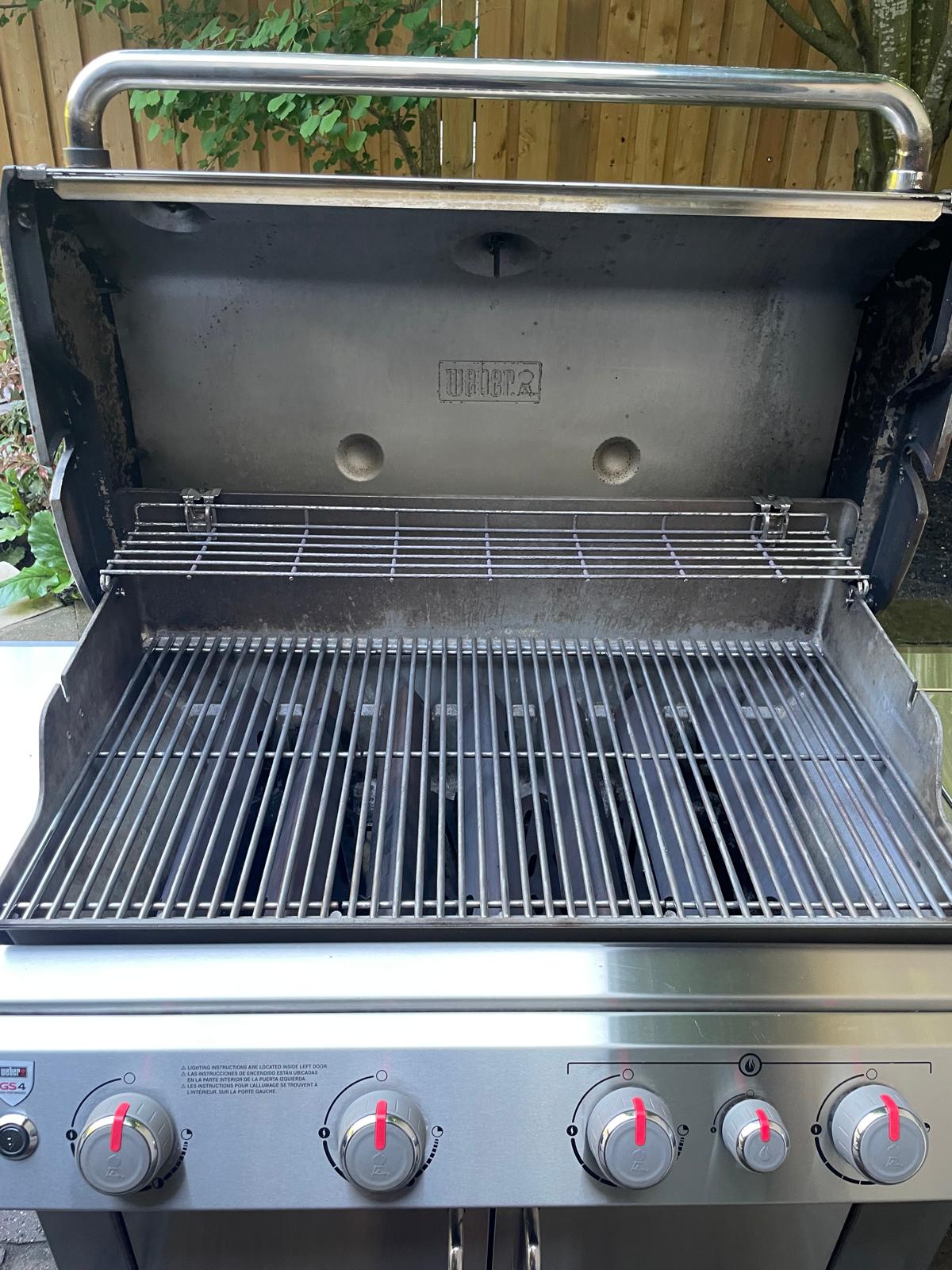 Inside that second four-burner Weber Genesis after an Aspect deep clean, with evenly cleaned cooking grates and a clear warming rack
