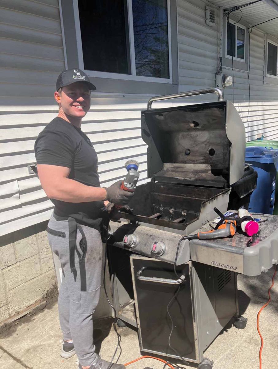 Aspect technician deep-cleaning a Weber Genesis