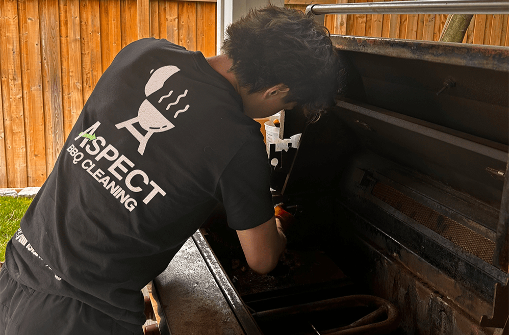 Aspect Home Services Ltd. (Formerly Shaidle Cleaning) BBQ cleaning technician cleaning a bbq professionally